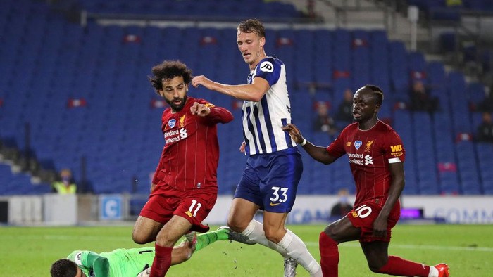 BRIGHTON, ENGLAND - JULY 08: Matthew Ryan of Brighton and Hove Albion collides with Mohamed Salah of Liverpool , Dan Burn of Brighton and Hove Albion and Sadio Mane of Liverpool  during the Premier League match between Brighton & Hove Albion and Liverpool FC at American Express Community Stadium on July 08, 2020 in Brighton, England. Football Stadiums around Europe remain empty due to the Coronavirus Pandemic as Government social distancing laws prohibit fans inside venues resulting in all fixtures being played behind closed doors. (Photo by Catherine Ivill/Getty Images)
