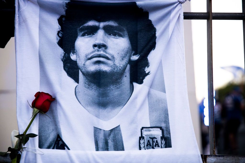 BUENOS AIRES, ARGENTINA - NOVEMBER 26: A shirt with the image of former football star Diego Maradona hangs on a fence on November 26, 2020 in Buenos Aires, Argentina. Diego Maradona, considered one of the biggest football stars in history, died at 60 from a heart attack on Wednesday in Buenos Aires.  (Photo by Tomas Cuesta/Getty Images)
