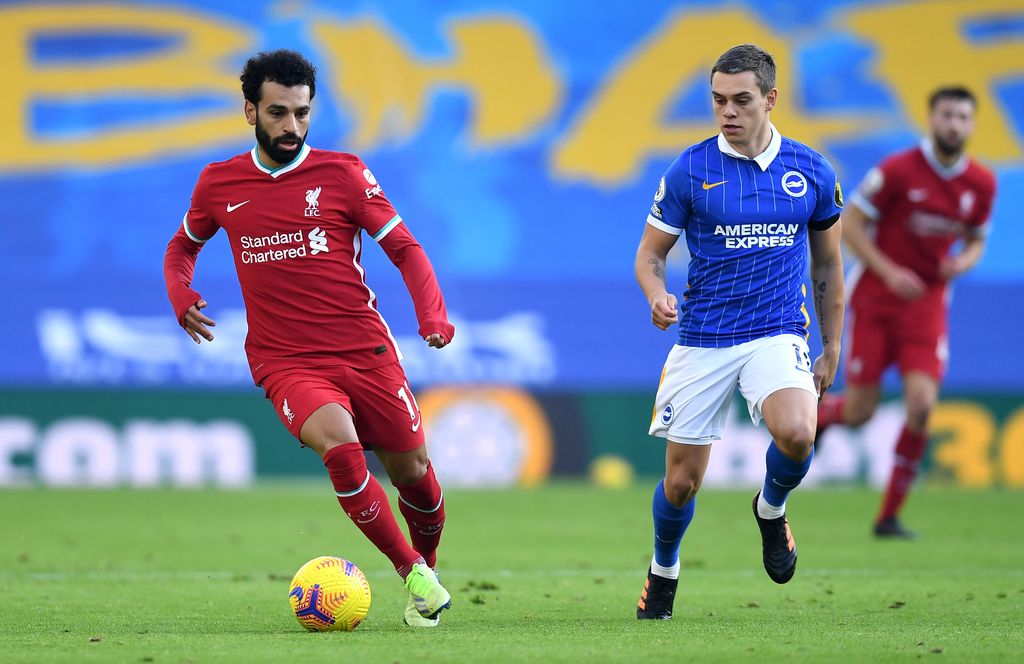 BRIGHTON, ENGLAND - NOVEMBER 28: Mohamed Salah of Liverpool is closed down by Leondro Trossard of Brighton and Hove Albion during the Premier League match between Brighton & Hove Albion and Liverpool at American Express Community Stadium on November 28, 2020 in Brighton, England. Sporting stadiums around the UK remain under strict restrictions due to the Coronavirus Pandemic as Government social distancing laws prohibit fans inside venues resulting in games being played behind closed doors. (Photo by Neil Hall - Pool/Getty Images)