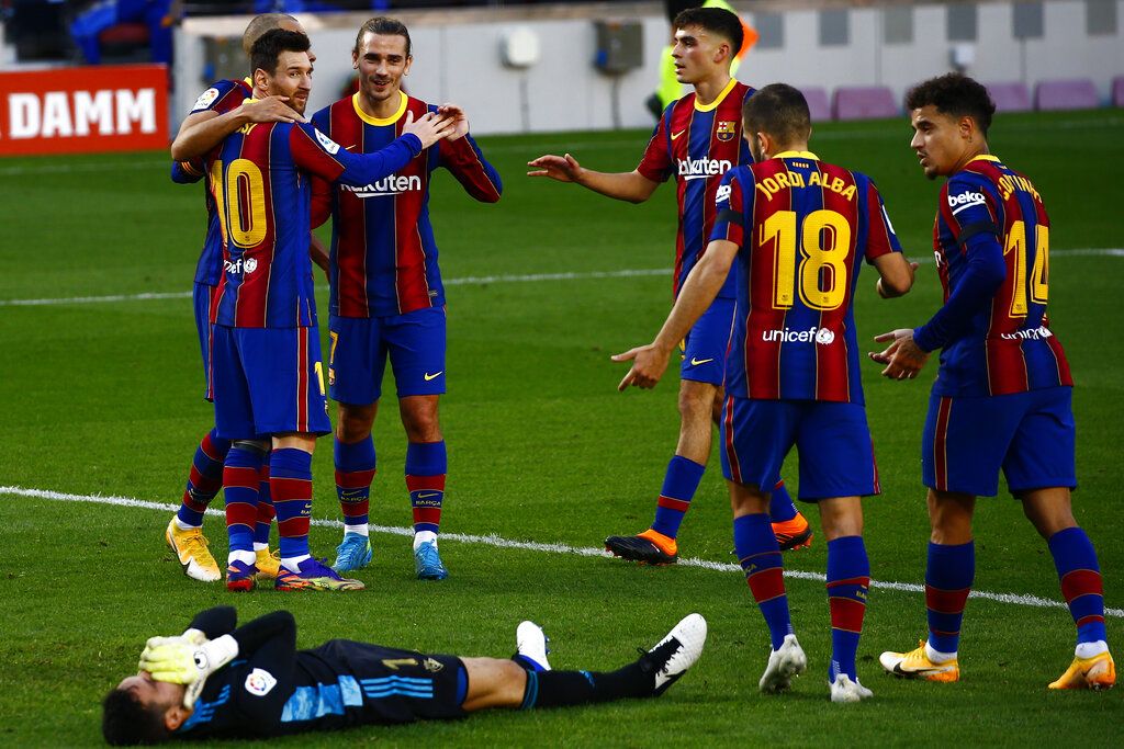 Barcelona's Martin Braithwaite, left, celebrates with his teammates after scoring his side's first goal during the Spanish La Liga soccer match between FC Barcelona and Osasuna at the Camp Nou stadium in Barcelona, Spain, Sunday, Nov. 29, 2020. (AP Photo/Joan Monfort)