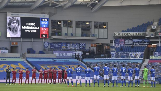 Birghton and Liverpool players pay their respect to soccer Legend Diego Maradona prior to the start of the English Premier League soccer match between Brighton and Hove Albion and Liverpool at the Amex stadium in Brighton, England, Saturday, Nov. 28, 2020. (Neil Hall/Pool Via AP)