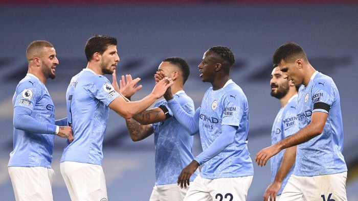 Manchester Citys Benjamin Mendy celebrates with teammates after scoring his sides third goal during the English Premier League soccer match between Manchester City and Burnley at the Etihad stadium in Manchester, England, Saturday, Nov. 28, 2020. (Laurence Griffiths/Pool via AP)