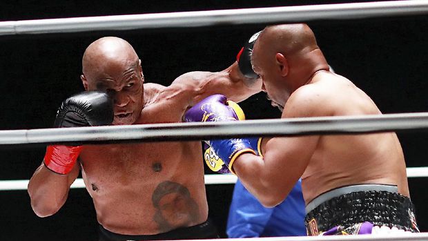In a photo provided by Triller, Mike Tyson throws a punch during the third round against Roy Jones Jr. in an exhibition boxing bout Saturday, Nov. 28, 2020, in Los Angeles. The bout was unofficially ruled a draw by the WBC judges at ringside. Tyson and Jones fought eight two-minute rounds, and both emerged smiling and apparently healthy from a highly unusual event. (Joe Scarnici/Triller via AP)