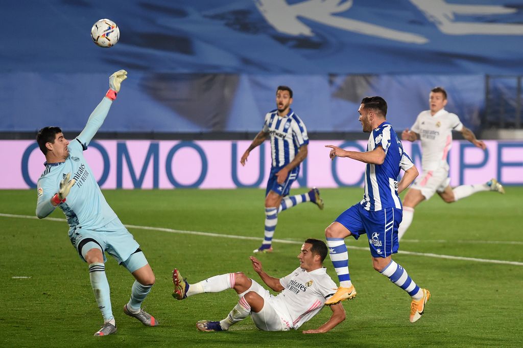 Real Madrid, Alaves MADRID, SPAIN - NOVEMBER 28: Thibaut Courtois of Real Madrid saves a shot from Lucas of Deportivo Alaves during the La Liga Santander match between Real Madrid and Deportivo Alaves at Estadio Santiago Bernabeu on November 28, 2020 in Madrid, Spain. Football Stadiums around Europe remain empty due to the Coronavirus Pandemic as Government social distancing laws prohibit fans inside venues resulting in fixtures being played behind closed doors. (Photo by Denis Doyle/Getty Images)
