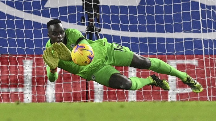 Chelseas goalkeeper Edouard Mendy saves a shot during the English Premier League soccer match between Chelsea and Tottenham Hotspur at Stamford Bridge in London, England, Sunday, Nov. 29, 2020. (Justin Tallis/Pool via AP)