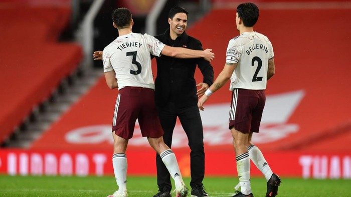 MANCHESTER, ENGLAND - NOVEMBER 01: Mikel Arteta, Manager of Arsenal, Kieran Tierney and Hector Bellerin of Arsenal celebrate following their teams victory in the Premier League match between Manchester United and Arsenal at Old Trafford on November 01, 2020 in Manchester, England. Sporting stadiums around the UK remain under strict restrictions due to the Coronavirus Pandemic as Government social distancing laws prohibit fans inside venues resulting in games being played behind closed doors. (Photo by Paul Ellis - Pool/Getty Images)