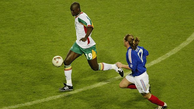 SEOUL - MAY 31:  Papa Bouba Diop (left) of Senegal is chased by Emmanuel Petit (right) of France during the France v Senegal Group A, World Cup Group  Stage match played at the Seoul World Cup Stadium, Seoul, South Korea on May 31, 2002. Senegal won the match 1-0. (Photo by Brian Bahr/Getty Images)