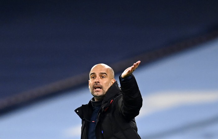 Manchester Citys head coach Pep Guardiola gives instructions to his players during the English Premier League soccer match between Manchester City and Burnley at the Etihad stadium in Manchester, England, Saturday, Nov. 28, 2020. (Michael Regan/Pool via AP)
