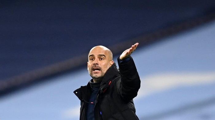 Manchester Citys head coach Pep Guardiola gives instructions to his players during the English Premier League soccer match between Manchester City and Burnley at the Etihad stadium in Manchester, England, Saturday, Nov. 28, 2020. (Michael Regan/Pool via AP)