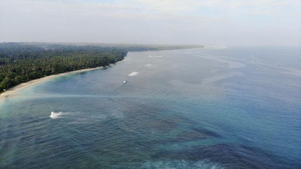 A surfer riding the wave at Tanjung Setia beach. Krui is located in West Lampung, Indonesia. lately, Krui had became one of famous tourism destination. It is known as a hidden paradise for the surfers all around the world. And Krui is an alternative surfing spot besides Bali.