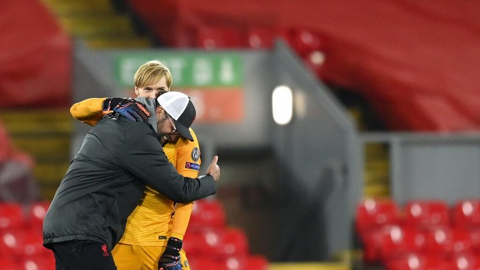 Liverpools manager Jurgen Klopp, left, celebrates with Liverpools goalkeeper Caoimhin Kelleher at the end of the Champions League group D soccer match between Liverpool and Ajax at Anfield stadium in Liverpool, England, Tuesday, Dec. 1, 2020. (Michael Regan/Pool via AP)