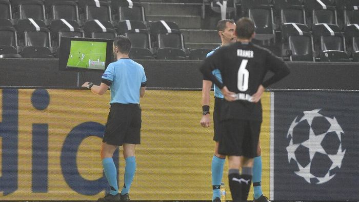 Germany Soccer Champions League Referee Danny Makkelie checks the VAR monitor during the Champions League, Group B, soccer match between Borussia Moenchengladbach and Inter Milan at the Borussia Park in Moenchengladbach, Germany, Tuesday, Dec. 1, 2020. (AP Photo/Martin Meissner)