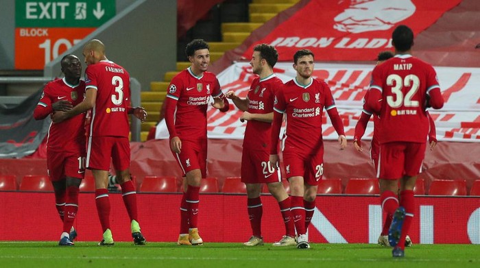 LIVERPOOL, ENGLAND - DECEMBER 01: Curtis Jones of Liverpool celebrates with Diogo Jota after scoring their teams first goal during the UEFA Champions League Group D stage match between Liverpool FC and Ajax Amsterdam at Anfield on December 01, 2020 in Liverpool, England. Sporting stadiums around the UK remain under strict restrictions due to the Coronavirus Pandemic as Government social distancing laws prohibit fans inside venues resulting in games being played behind closed doors. (Photo by Peter Byrne - Pool/Getty Images)