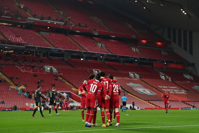 LIVERPOOL, ENGLAND - DECEMBER 01: General view inside the stadium as Curtis Jones of Liverpool celebrates with Sadio Mane and Andrew Robertson after scoring their teams first goal during the UEFA Champions League Group D stage match between Liverpool FC and Ajax Amsterdam at Anfield on December 01, 2020 in Liverpool, England. Sporting stadiums around the UK remain under strict restrictions due to the Coronavirus Pandemic as Government social distancing laws prohibit fans inside venues resulting in games being played behind closed doors. (Photo by Paul Ellis - Pool/Getty Images)
