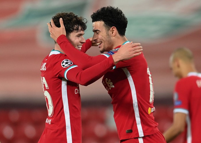 LIVERPOOL, ENGLAND - DECEMBER 01: Curtis Jones of Liverpool celebrates with teammate Neco Williams after scoring his teams first goal during the UEFA Champions League Group D stage match between Liverpool FC and Ajax Amsterdam at Anfield on December 01, 2020 in Liverpool, England. Sporting stadiums around the UK remain under strict restrictions due to the Coronavirus Pandemic as Government social distancing laws prohibit fans inside venues resulting in games being played behind closed doors. (Photo by Michael Regan/Getty Images)