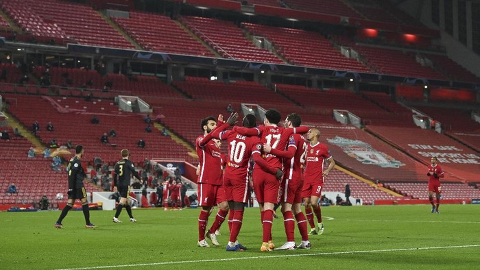 Liverpool players celebrate scoring their sides first goal during the Champions League group D soccer match between Liverpool and Ajax at Anfield stadium in Liverpool, England, Tuesday, Dec. 1, 2020. (Paul Ellis/Pool via AP)