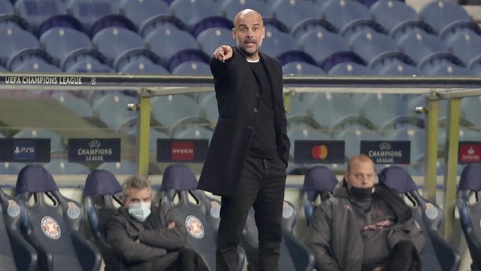 Manchester Citys head coach Pep Guardiola gestures during the Champions League group C soccer match between FC Porto and Manchester City at the Dragao stadium in Porto, Portugal, Tuesday, Dec. 1, 2020. (AP Photo/Luis Vieira)