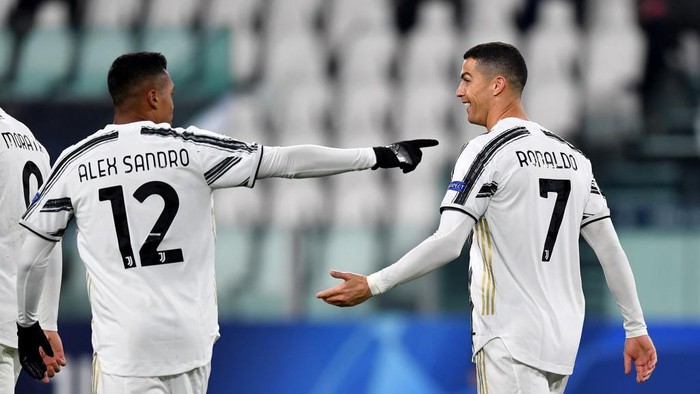 TURIN, ITALY - DECEMBER 02: Cristiano Ronaldo of Juventus celebrates with team mate Alex Sandro (L) after scoring their sides second goal during the UEFA Champions League Group G stage match between Juventus and Dynamo Kyiv at Allianz Stadium on December 02, 2020 in Turin, Italy. Sporting stadiums around Italy remain under strict restrictions due to the Coronavirus Pandemic as Government social distancing laws prohibit fans inside venues resulting in games being played behind closed doors. (Photo by Valerio Pennicino/Getty Images)