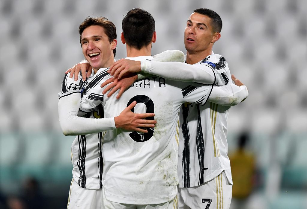 TURIN, ITALY - DECEMBER 02: Alvaro Morata of Juventus(C) celebrates after scoring their sides third goal with Federico Chiesa of Juventus(L) and Cristiano Ronaldo of Juventus(R) during the UEFA Champions League Group G stage match between Juventus and Dynamo Kyiv at Allianz Stadium on December 02, 2020 in Turin, Italy. Sporting stadiums around Italy remain under strict restrictions due to the Coronavirus Pandemic as Government social distancing laws prohibit fans inside venues resulting in games being played behind closed doors. (Photo by Valerio Pennicino/Getty Images)
