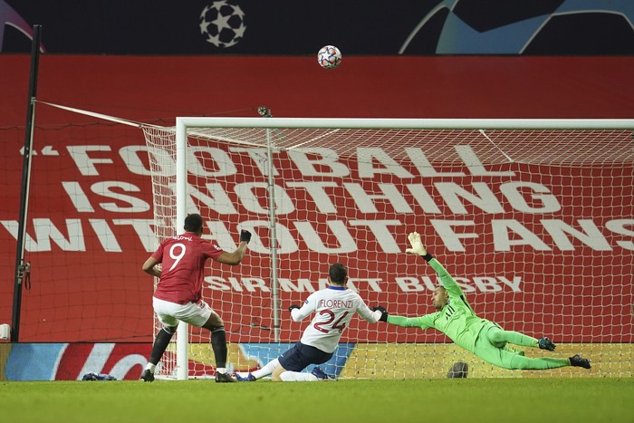 Manchester Uniteds Anthony Martial, left, shoots the ball over the bar during a Group H Champions League soccer match between Manchester United and Paris Saint Germain at the Old Trafford stadium in Manchester, England, Wednesday, Dec. 2, 2020. (AP Photo/Dave Thompson)