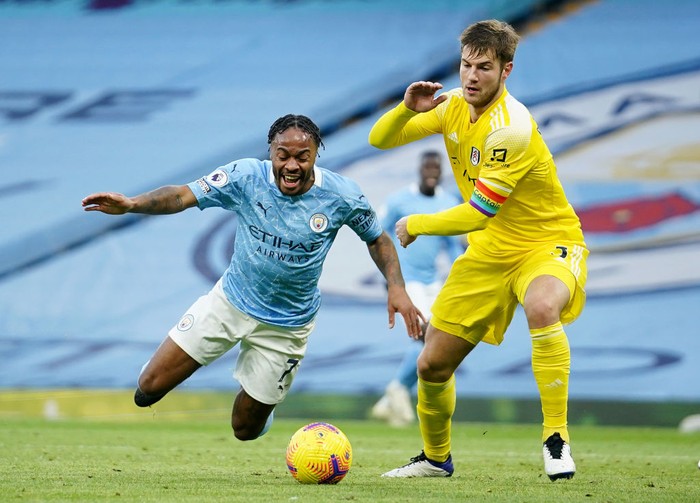 MANCHESTER, ENGLAND - DECEMBER 05: Raheem Sterling of Manchester City is fouled by Joachim Andersen of Fulham, leading to Manchester City being awarded a penalty during the Premier League match between Manchester City and Fulham at Etihad Stadium on December 05, 2020 in Manchester, England. The match will be played without fans, behind closed doors as a Covid-19 precaution. (Photo by Dave Thompson - Pool/Getty Images)
