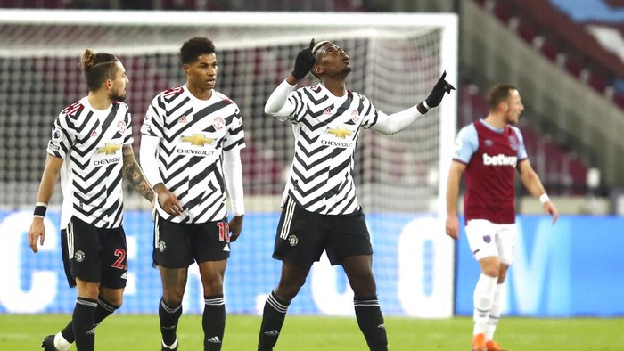 Manchester Uniteds Paul Pogba celebrates after scoring his sides opening goal during the English Premier League soccer match between West Ham United and Manchester United at the London stadium in London, England, Saturday, Dec. 5, 2020. (Julian Finney/Pool Via AP)