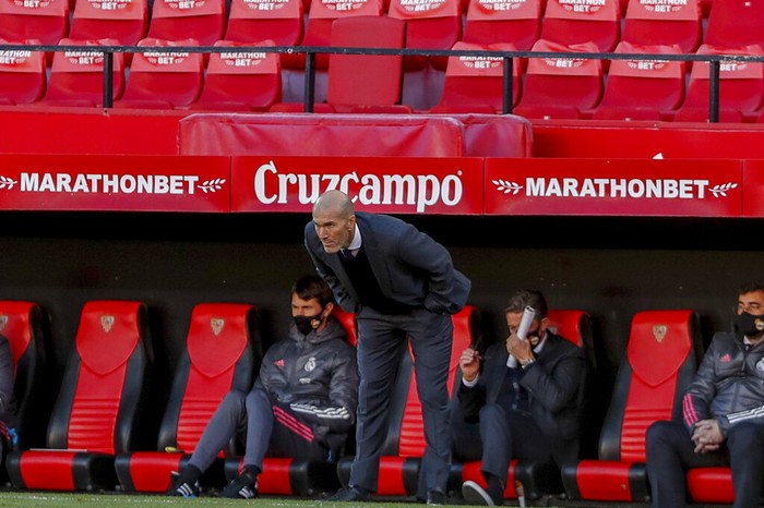 Real Madrids head coach Zinedine Zidane watches the play during the Spanish La Liga soccer match between Sevilla and Real Madrid at the Ramon Sanchez Pizjuan stadium in Seville, Spain, Saturday Dec. 5, 2020. (AP Photo/Angel Fernandez)