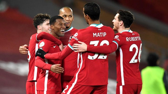 LIVERPOOL, ENGLAND - DECEMBER 06: Georginio Wijnaldum of Liverpool celebrates with team mates Fabinho, Andy Robertson, Joel Matip and Neco Williams after scoring their sides second goal during the Premier League match between Liverpool and Wolverhampton Wanderers at Anfield on December 06, 2020 in Liverpool, England. A limited number of fans (2000) are welcomed back to stadiums to watch elite football across England. This was following easing of restrictions on spectators in tiers one and two areas only. (Photo by Peter Powell - Pool/Getty Images)