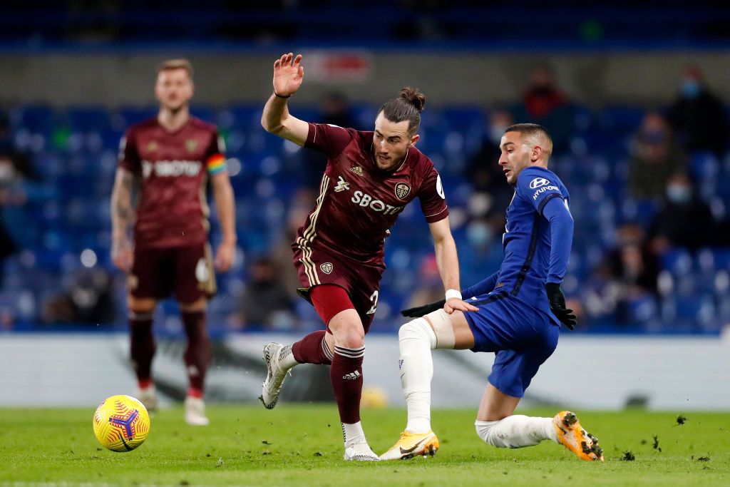 LONDON, ENGLAND - DECEMBER 05: Jack Harrison of Leeds United is tackled by Hakim Ziyech of Chelsea during the Premier League match between Chelsea and Leeds United at Stamford Bridge on December 05, 2020 in London, England. A limited number of fans are welcomed back to stadiums to watch elite football across England. This was following easing of restrictions on spectators in tiers one and two areas only. (Photo by Matthew Childs - Pool/Getty Images)