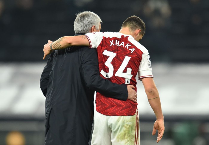 LONDON, ENGLAND - DECEMBER 06: Jose Mourinho, Manager of Tottenham Hotspur embraces Granit Xhaka of Arsenal following the Premier League match between Tottenham Hotspur and Arsenal at Tottenham Hotspur Stadium on December 06, 2020 in London, England. A limited number of fans (2000) are welcomed back to stadiums to watch elite football across England. This was following easing of restrictions on spectators in tiers one and two areas only. (Photo by Glyn Kirk - Pool/Getty Images)
