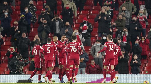 Liverpool's Joel Matip, center left, celebrates after scoring his side's third goal during the English Premier League soccer match between Liverpool and Wolverhampton Wanderers at Anfield Stadium, Liverpool, England, Sunday, Dec. 6, 2020. (AP photo/Jon Super, Pool)