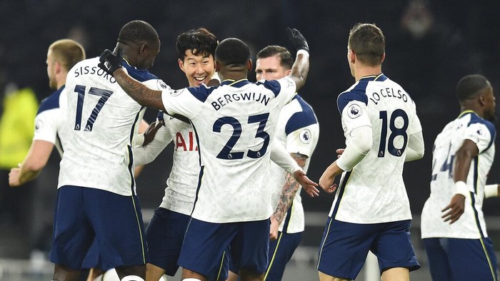 Tottenham players celebrate with Son Heung-min, third left, who scored his sides first goal during the English Premier League soccer match between Tottenham Hotspur and Arsenal at Tottenham Hotspur Stadium in London, England, Sunday, Dec. 6, 2020. (Glyn Kirk/Pool via AP)