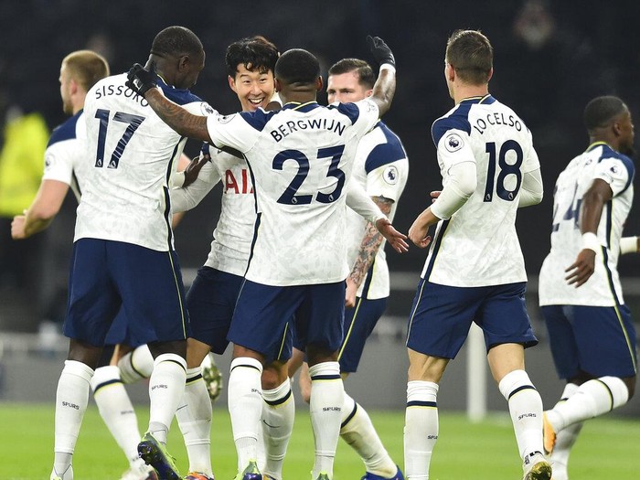 Tottenham players celebrate with Son Heung-min, third left, who scored his side's first goal during the English Premier League soccer match between Tottenham Hotspur and Arsenal at Tottenham Hotspur Stadium in London, England, Sunday, Dec. 6, 2020. (Glyn Kirk/Pool via AP)