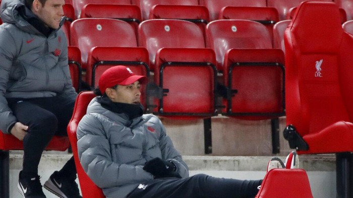 Liverpools Virgil van Dijk, center, watches from the stands during the English Premier League soccer match between Liverpool and Wolverhampton Wanderers at Anfield Stadium, Liverpool, England, Sunday, Dec. 6, 2020. (Clive Brunskill/Pool via AP)