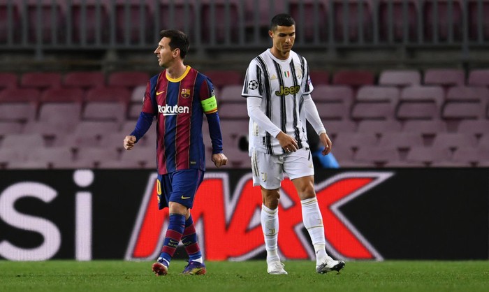 BARCELONA, SPAIN - DECEMBER 08: Lionel Messi of Barcelona (L) and Cristiano Ronaldo of Juventus F.C. (R) look on during the UEFA Champions League Group G stage match between FC Barcelona and Juventus at Camp Nou on December 08, 2020 in Barcelona, Spain. Sporting stadiums around Spain remain under strict restrictions due to the Coronavirus Pandemic as Government social distancing laws prohibit fans inside venues resulting in games being played behind closed doors. (Photo by David Ramos/Getty Images)