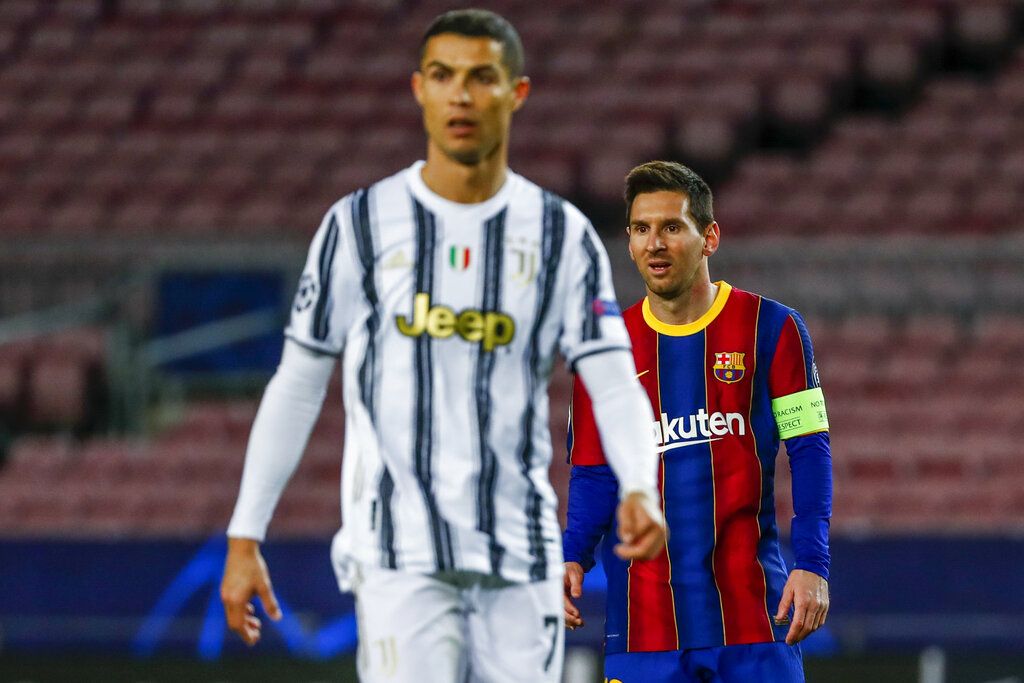 Barcelona's Lionel Messi, left, shakes has with Juventus' Cristiano Ronaldo prior of the start of the Champions League group G soccer match between FC Barcelona and Juventus at the Camp Nou stadium in Barcelona, Spain, Tuesday, Dec. 8, 2020. (AP Photo/Joan Monfort)