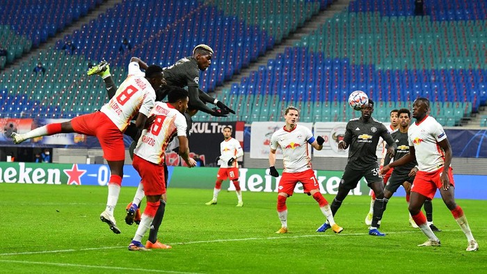 LEIPZIG, GERMANY - DECEMBER 08: Harry Maguire of Manchester United (obscured) scores his sides second goal during the UEFA Champions League Group H stage match between RB Leipzig and Manchester United at Red Bull Arena on December 08, 2020 in Leipzig, Germany. Sporting stadiums around Germany remain under strict restrictions due to the Coronavirus Pandemic as Government social distancing laws prohibit fans inside venues resulting in games being played behind closed doors. (Photo by Stuart Franklin/Getty Images)