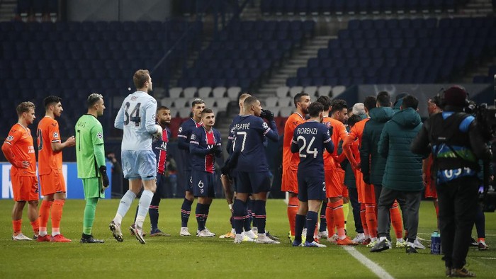 Players of Paris Saint Germain, and Istanbul Basaksehir leave the pitch, during the Champions League group H soccer match between Paris Saint Germain and Istanbul Basaksehir at the Parc des Princes stadium in Paris, Tuesday Dec. 8 , 2020. Basaksehirs assistant coach Pierre Webo was shown a straight red card in the 16th minute before the players refused to continue the match amid allegations of racism by one of the match officials. (AP Photo/Francois Mori)
