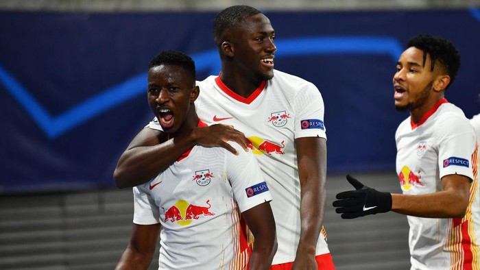 LEIPZIG, GERMANY - DECEMBER 08: Amadou Haidara of RB Leipzig (L) celebrates with teammates Ibrahima Konate and Christopher Nkunku after scoring their sides second goal during the UEFA Champions League Group H stage match between RB Leipzig and Manchester United at Red Bull Arena on December 08, 2020 in Leipzig, Germany. Sporting stadiums around Germany remain under strict restrictions due to the Coronavirus Pandemic as Government social distancing laws prohibit fans inside venues resulting in games being played behind closed doors. (Photo by Stuart Franklin/Getty Images)