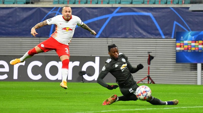 LEIPZIG, GERMANY - DECEMBER 08: Angelino of RB Leipzig scores their teams first goal as Aaron Wan-Bissaka of Manchester United attempts to block during the UEFA Champions League Group H stage match between RB Leipzig and Manchester United at Red Bull Arena on December 08, 2020 in Leipzig, Germany. Sporting stadiums around Germany remain under strict restrictions due to the Coronavirus Pandemic as Government social distancing laws prohibit fans inside venues resulting in games being played behind closed doors. (Photo by Stuart Franklin/Getty Images)