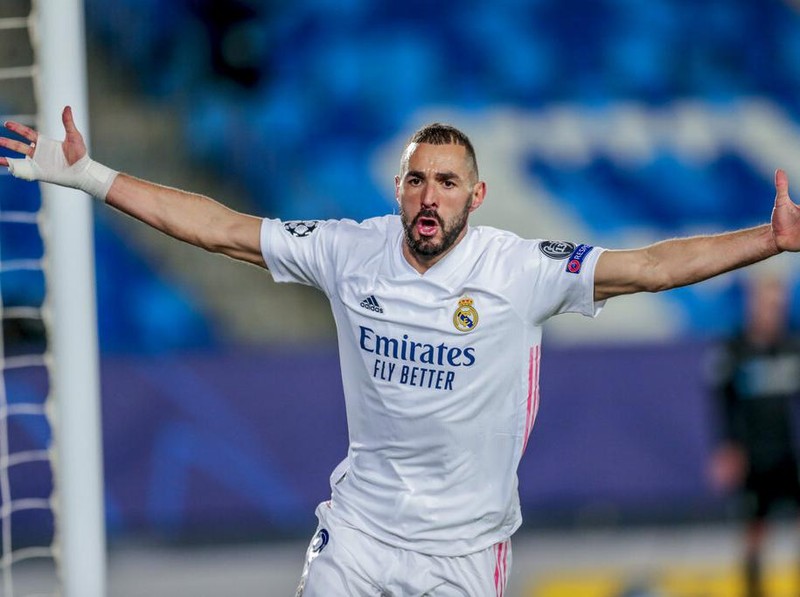 Real Madrid's Karim Benzema celebrates after scoring the opening goal during the Champions League group B soccer match between Real Madrid and Borussia Monchengladbach at the Alfredo Di Stefano stadium in Madrid, Spain, Wednesday, Dec. 9, 2020. (AP Photo/Bernat Armangue)