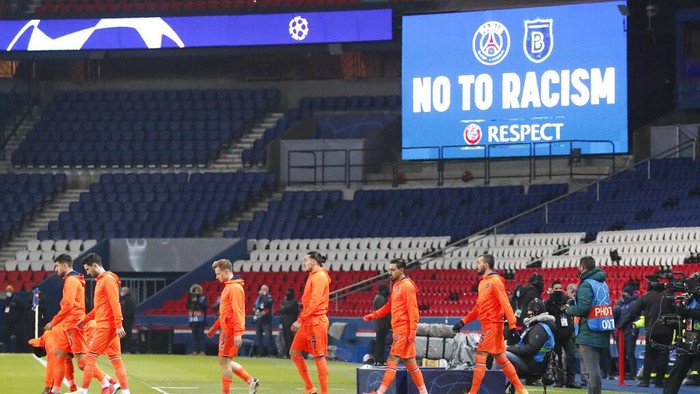 Basaksehir players arrive on the pitch before the start of the Champions League group H soccer match between Paris Saint Germain and Istanbul Basaksehir at the Parc des Princes stadium in Paris, France, Wednesday, Dec. 9, 2020. The match is resuming on Wednesday with a new refereeing team after players from Paris Saint-Germain and Istanbul Basaksehir left the field on Tuesday evening and didnt return when the fourth official — Sebastian Coltescu of Romania — was accused of using a racial term to identify Basaksehir assistant coach Pierre Webo before sending him off for his conduct on the sidelines. (AP Photo/Francois Mori)