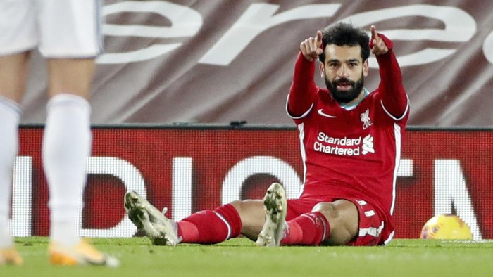 Liverpools Mohamed Salah, right, celebrates after scoring the opening goal during the English Premier League soccer match between Liverpool and Wolverhampton Wanderers at Anfield Stadium, Liverpool, England, Sunday, Dec. 6, 2020. (Clive Brunskill/Pool via AP)