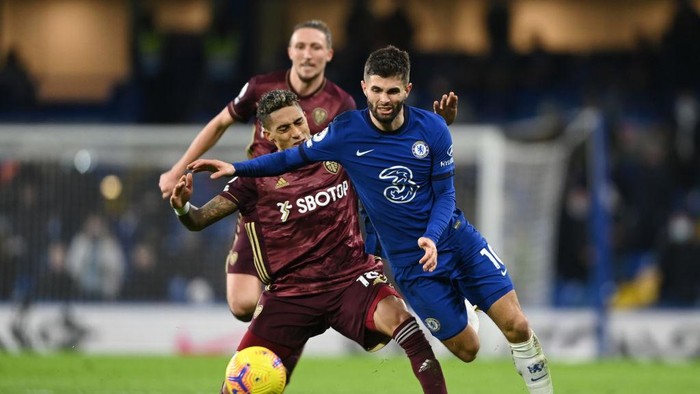 LONDON, ENGLAND - DECEMBER 05: Christian Pulisic of Chelsea is tackled by Raphinha of Leeds United during the Premier League match between Chelsea and Leeds United at Stamford Bridge on December 05, 2020 in London, England. A limited number of fans are welcomed back to stadiums to watch elite football across England. This was following easing of restrictions on spectators in tiers one and two areas only. (Photo by Mike Hewitt/Getty Images)