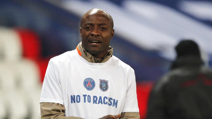 Basaksehir assistant coach Pierre Webo prior to the Champions League group H soccer match between Paris Saint Germain and Istanbul Basaksehir at the Parc des Princes stadium in Paris, France, Wednesday, Dec. 9, 2020. The match is resuming on Wednesday with a new refereeing team after players from Paris Saint-Germain and Istanbul Basaksehir left the field on Tuesday evening and didn’t return when the fourth official — Sebastian Coltescu of Romania — was accused of using a racial term to identify Basaksehir assistant coach Pierre Webo before sending him off for his conduct on the sidelines.  (AP Photo/Francois Mori)