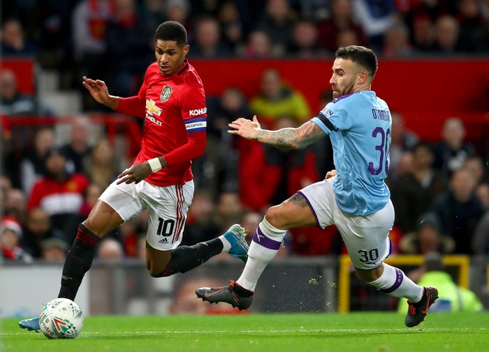 MANCHESTER, ENGLAND - JANUARY 07: Marcus Rashford of Manchester United is challenged by Nicolas Otamendi of Manchester City during the Carabao Cup Semi Final match between Manchester United and Manchester City at Old Trafford on January 07, 2020 in Manchester, England. (Photo by Michael Steele/Getty Images)