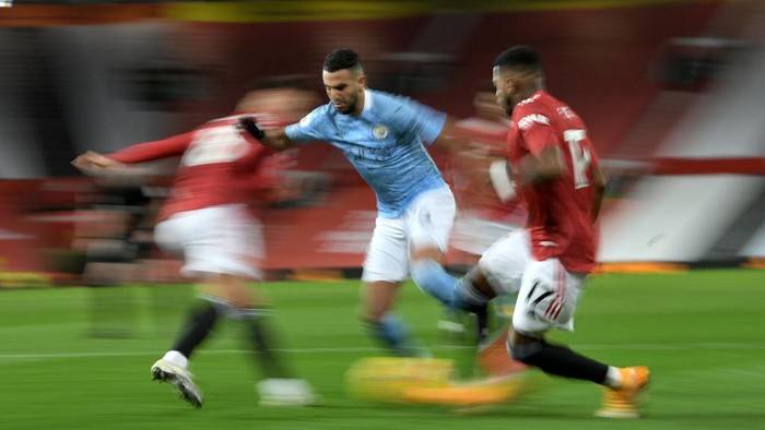 MANCHESTER, ENGLAND - DECEMBER 12: Riyad Mahrez of Manchester City  runs with the ball during the Premier League match between Manchester United and Manchester City at Old Trafford on December 12, 2020 in Manchester, England. The match will be played without fans, behind closed doors as a Covid-19 precaution. (Photo by Michael Regan/Getty Images)