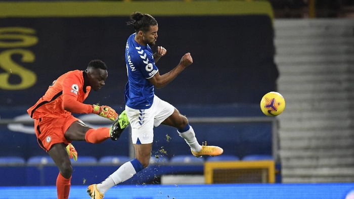 Chelseas goalkeeper Edouard Mendy, left, makes a save in front of Evertons Dominic Calvert-Lewin during the English Premier League soccer match between Everton and Chelsea at Goodison Park in Liverpool, England, Saturday, Dec. 12, 2020. (Peter Powell/Pool via AP)