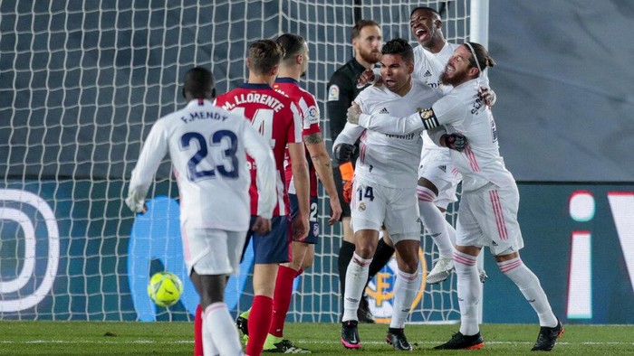 Real Madrids Casemiro, center, celebrates after scoring his sides first goal during the Spanish La Liga soccer match between Real Madrid and Atletico Madrid at the Alfredo Di Stefano stadium in Madrid, Spain, Saturday, Dec. 12, 2020. (AP Photo/Bernat Armangue)