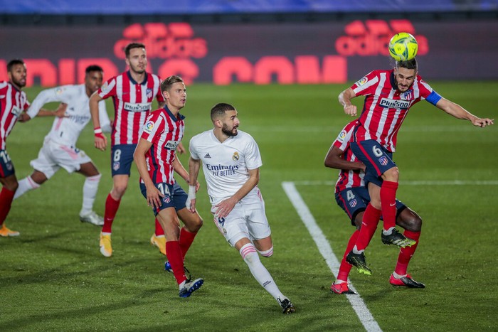 Atletico Madrids Koke, right, heads for the ball during the Spanish La Liga soccer match between Real Madrid and Atletico Madrid at the Alfredo Di Stefano stadium in Madrid, Spain, Saturday, Dec. 12, 2020. (AP Photo/Bernat Armangue)